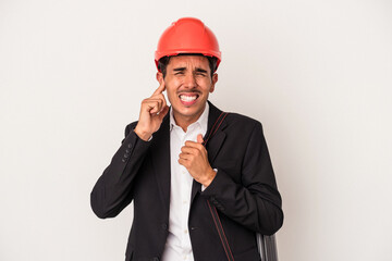 Young architect mixed race man isolated on white background covering ears with hands.