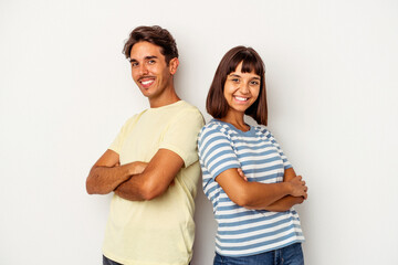 Fototapeta premium Young mixed race couple isolated on white background who feels confident, crossing arms with determination.