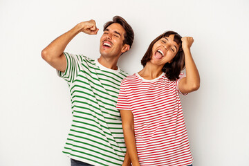 Young mixed race couple isolated on white background celebrating a victory, passion and enthusiasm, happy expression.