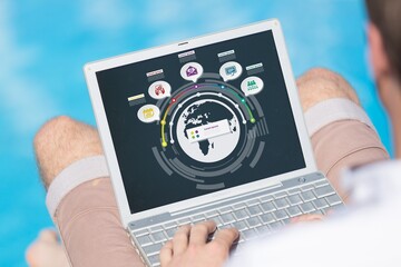 Man using software on laptop with different graphs and charts