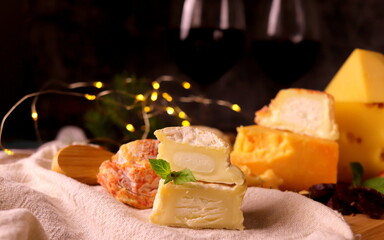 different types of cheeses on the board close-up selective focus.