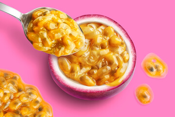 Half passionfruit with pulp, spoon and drops on a pink purple background, photographed from above.