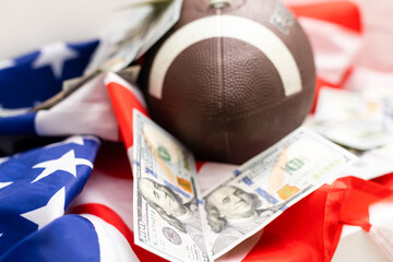 rugby ball and dollars on american flag