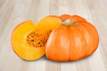 Set of fresh whole and sliced pumpkin on the desk