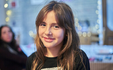 Portrait of a beautiful Caucasian girl with long hair looking at camera