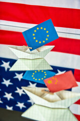 Fototapeta premium paper ship with Flags of EU Europe union, USA and China - concept for relations between countries, agreement, conflict, political tension