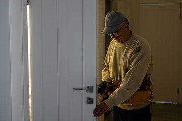 handyman repair the door lock in the room