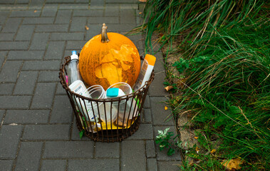 Halloween pumpkin carved and illuminated. Earth planet zero waste holidays and trash.