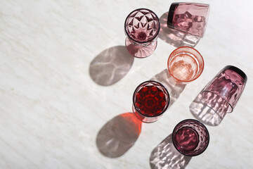 Beautiful empty red glasses on light background