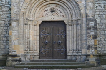 Fototapeta na wymiar Entrance portal to the catholic parish church Saint Caecilia from 1886 in the municipality of Harsum, a village in the district of Hildesheim, in Lower Saxony, Germany.