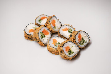 Sushi roll with salmon. Traditional Japanese cuisine side view.