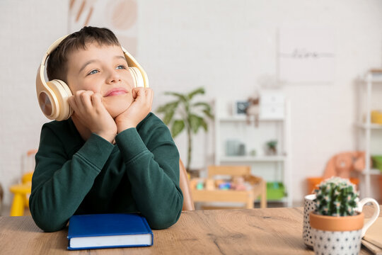 Little boy listening to audiobook at home