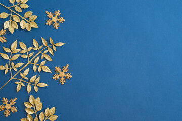 Christmas holiday composition. Flat lay frame with christmas golden decorations on a blue background