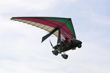 	
Ultralight airplane flying in a blue sky