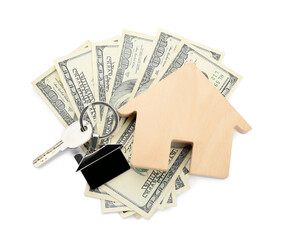 Wooden figure of house, key with keychain and money on white background