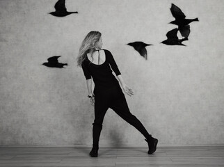 Dancing with birds . Freedom concept. Black and white photography