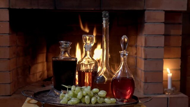 A large selection of alcoholic tinctures on the background of the fireplace