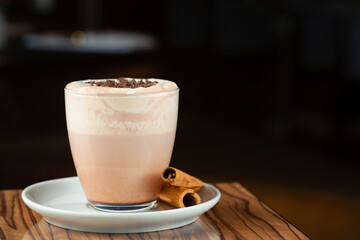 hot cocoa on wooden table closeup with copy space on dark background