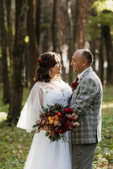 walk of the bride and groom through the autumn forest