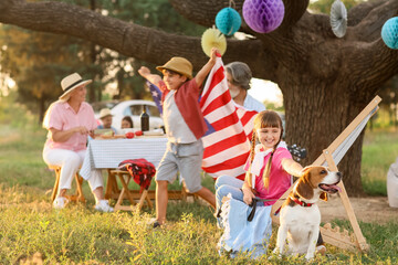 Happy family at barbecue party on summer day