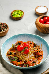 griiled shrimp with tomatoes sauce and rice close up in plate on concrete table with ingredients on background