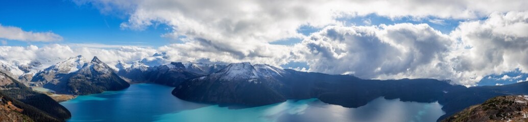Panoramic landscape view of Garibaldi Lake. Sunny and cloudy Fall Day. Taken from top of Panorama Ridge, located near Whister and Squamish, North of Vancouver, BC, Canada.