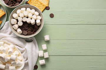 Ingredients for preparing S'mores dip on color wooden background