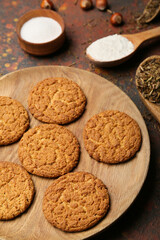 Plate with tasty hojicha cookies on grunge background
