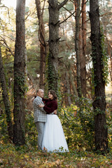 walk of the bride and groom through the autumn forest
