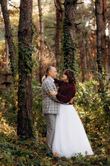 walk of the bride and groom through the autumn forest