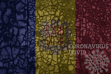 flag of andorra on a old metal rusty cracked wall with text coronavirus, covid, and virus picture.