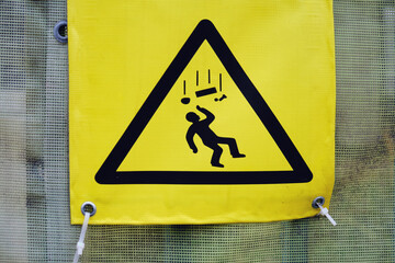 A sign of falling objects, debris and bricks on the fence near the construction site - Moscow,...