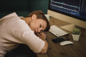 Fototapeta na wymiar Tired Woman Sleeping While Trading With Cryptocurrency At Late Night