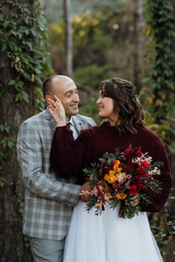 walk of the bride and groom through the autumn forest