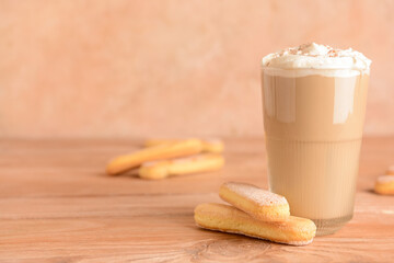 Glass of tasty Tiramisu Latte on table