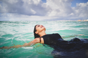 Smiling woman relaxing in clear sea