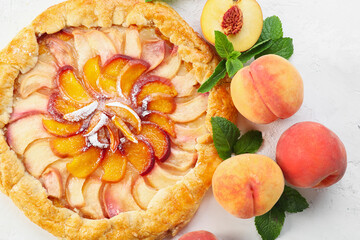 Tasty peach galette on light background, closeup