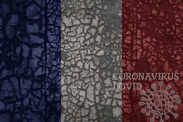 flag of france on a old metal rusty cracked wall with text coronavirus, covid, and virus picture.
