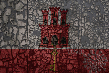 flag of gibraltar on a old metal rusty cracked wall with text coronavirus, covid, and virus picture.
