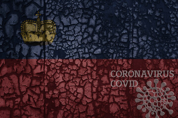 flag of liechtenstein on a old metal rusty cracked wall with text coronavirus, covid, and virus picture.