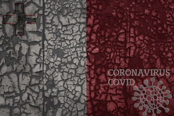 flag of malta on a old metal rusty cracked wall with text coronavirus, covid, and virus picture.