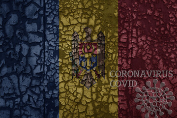 flag of moldova on a old metal rusty cracked wall with text coronavirus, covid, and virus picture.