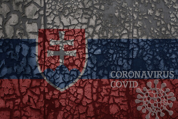 flag of slovakia on a old metal rusty cracked wall with text coronavirus, covid, and virus picture.