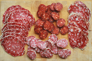 Traditional salami sliced and dry sausage on cutting board