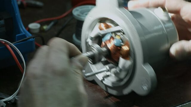 Electricians hands testing current electric in control panel. Electrician engineer work tester measuring voltage and current of power electric line in electical cabinet control. 4K FOOTAGE
