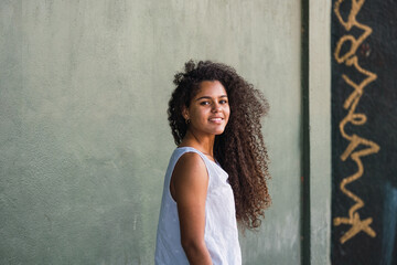 Portrait of a teenage cuban woman girl from the back turning her face to the camera
