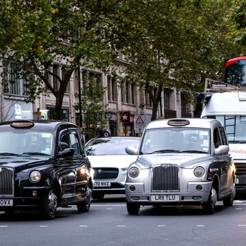 Traditional London Taxi’s Or Cabs Vehicles On A London Street