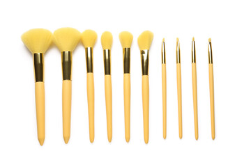 Different beautiful makeup brushes on white background