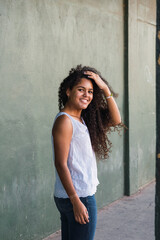 Portrait of a teenage cuban woman girl from the back turning her face to the camera