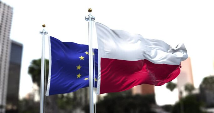 The flags of Poland and the European Union waving in the wind